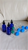 Vintage craft storage assortment with jumbo tubes, small glass bottles, and cobalt blue dauber bottles