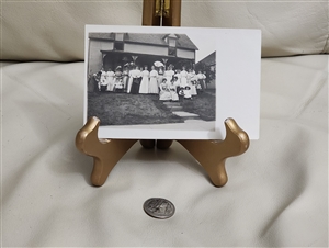 Antique Real Photo Postcard of a large family gathering in front of a house from the early 1900s
