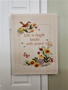 Needlepoint canvas with phrase birds and flowers in multicolor stretched over wooden frame