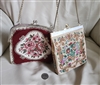 Two vintage purses including a red floral petit point evening bag and a colorful woven tapestry clutch with chain straps