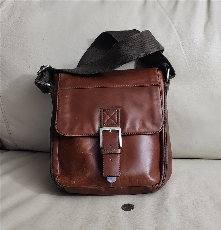 2011 Fossil SML3889 brown leather messenger crossbody bag featuring front flap buckle closure, durable canvas shoulder strap, and exterior zip pocket