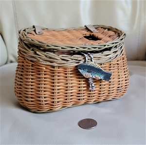 Vintage woven wicker fishing creel basket showing hinged lid top entry slot and carved painted fish closure