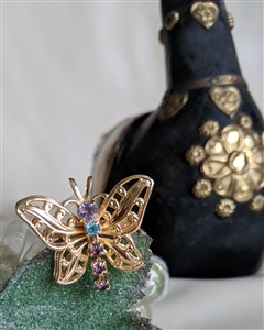 Vintage 1980s gold tone filigree butterfly brooch pendant with purple rhinestones and dangling tail front and back views