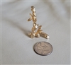 Vintage 1960s Sarah Coventry gold tone bamboo shoot letter L brooch front and back views with coin for scale