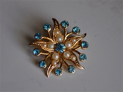 Vintage Coro gold tone starburst floral brooch with faux pearls and light blue glass rhinestones