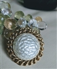 Vintage Sarah Coventry round statement brooch with faux mother of pearl center and gold tone woven chain border