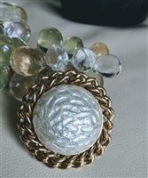 Vintage Sarah Coventry domed round brooch featuring faux mother of pearl center and woven chain border