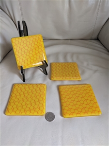 Pre-owned vintage 1970s set of four geometric art glass coasters in yellow and orange for table decor