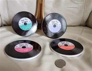 Twos Company four circular glass coasters shaped like vinyl records with colorful center labels and realistic grooves