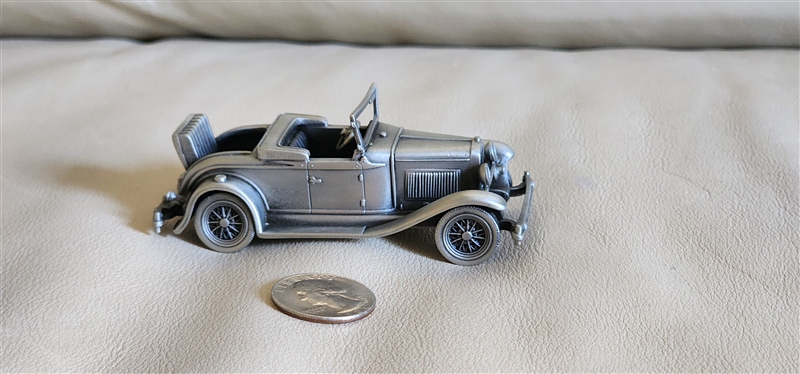 Vintage 1975 pewter 1930 Model A Roadster model car by Danbury Mint England showing authentic underside hallmark and open-top design details
