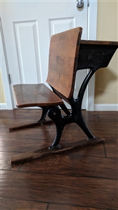 Antique AH Andrews Co Chicago cast iron and wood folding school desk bench side view showing embossed maker logo