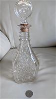 Vintage pressed glass decanter with leaves and vines design and fleur de lis stopper