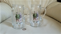 vintage set of two 1980 glass beer steins in shape of golf bags with two golfer decoupage marked canada barware in preowned condition