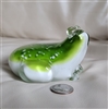 This preowned vintage large glass frog paperweight features a lemon green and white color scheme
