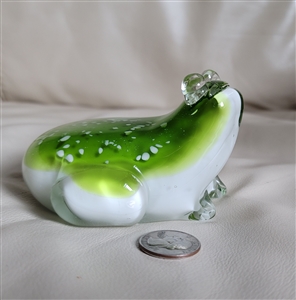 This preowned vintage large glass frog paperweight features a lemon green and white color scheme