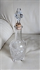 Antique four-footed etched glass decanter with star cut base and cork stopper