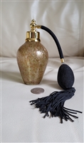 Shimmering gold tone covered glass perfume bottle