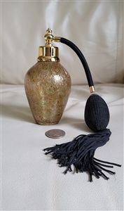Shimmering gold tone covered glass perfume bottle