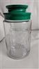 Pre-owned vintage embossed glass Tang kitchen storage jar with teal plastic screw-on lid for organization or collection