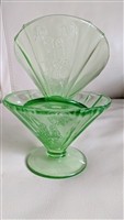 Two green transparent footed sherbet glasses with a ribbed cone shape on a neutral background showing the Parrot Green pattern