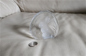 A clear vintage 24 percent lead crystal bunny rabbit figurine from Yugoslavia shown next to a coin for scale