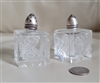 Set of two vintage square clear glass salt and pepper shakers with floral design and sterling silver lids