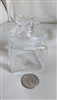 Vintage small clear glass apothecary bottle showing square body and decorative matching glass stopper
