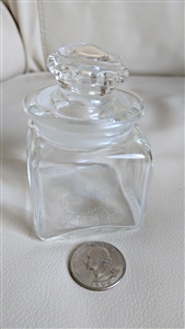 Vintage small clear glass apothecary bottle showing square body and decorative matching glass stopper