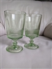 Two spring green glass goblets with vertical ribbed optic lines and starburst base pattern marked MSG 26