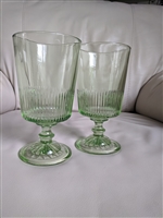 Two spring green glass goblets with vertical ribbed optic lines and starburst base pattern marked MSG 26