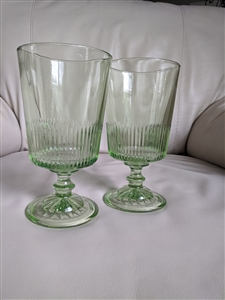 Two spring green glass goblets with vertical ribbed optic lines and starburst base pattern marked MSG 26