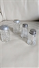 Vintage set of four glass salt and pepper shakers with checkered and striped designs