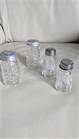 Vintage set of four glass salt and pepper shakers with checkered and striped designs