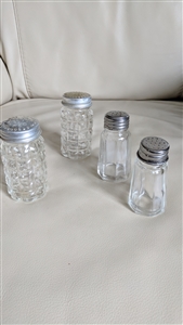 Vintage set of four glass salt and pepper shakers with checkered and striped designs