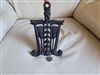 Vintage trivet by J.Z.H. 1951 in black color and elaborate design kitchen accessory.