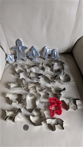 Set of 23 mid century steel aluminum and red plastic cookie cutters in various animal and holiday shapes from the 1960s