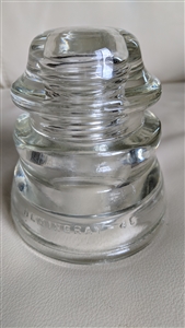 This preowned vintage clear glass Hemingray 46 utility insulator features a classic industrial design
