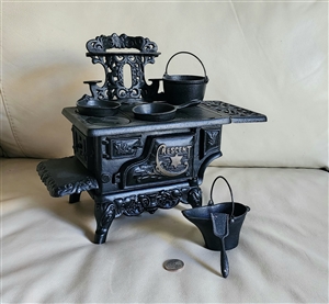 Preowned vintage Crescent cast iron salesman sample stove decorative display with miniature accessories front view