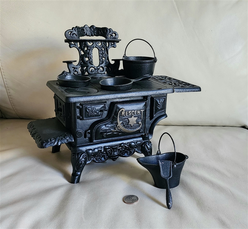 Preowned vintage Crescent cast iron salesman sample stove decorative display with miniature accessories front view