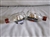 1970s pair of miniature ships in a bottle featuring handcrafted topsail schooners on wooden display stands for nautical decor.