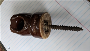 This preowned vintage Kearney chocolate brown ceramic spool insulator includes its original mounting screw