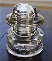 This preowned vintage Armstrong 51-C1 clear glass utility insulator features its classic industrial embossed design