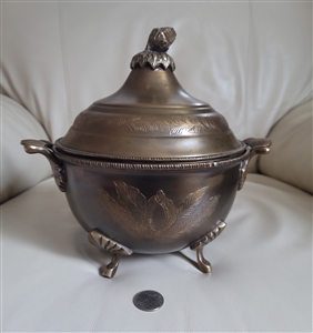 Large vintage ornate brass footed urn with side handles and an acorn finial on the lid