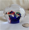 Vintage clear glass paperweight featuring an internal reef scene with colorful fish and bubble inclusions