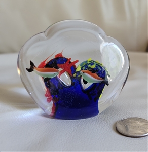 Vintage clear glass paperweight featuring an internal reef scene with colorful fish and bubble inclusions