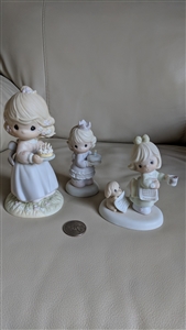 The front view shows three Precious Moments girl figurines including one holding a birthday cake, one holding a puppy, and another girl in a blue dress