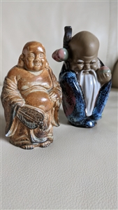 Set of two vintage ceramic figurines including a blue glazed Shiwan God of Longevity and a brown Japanese Laughing Buddha
