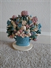 Vintage hand painted cast iron doorstop featuring mixed flowers in a blue basket on a base