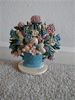 Vintage hand painted cast iron doorstop featuring mixed flowers in a blue basket on a base