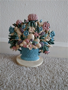 Vintage hand painted cast iron doorstop featuring mixed flowers in a blue basket on a base